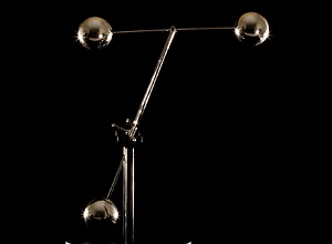 A nested pendulum with three balls and a magnet in the ground.