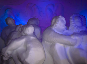 A group of snow sculptures illuminated with blue light.