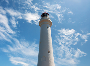 White lighthouse in the blue sky.