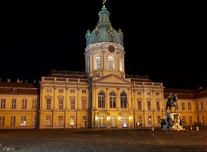 Illuminated Charlottenburg Palace in Berlin at night.