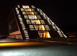 Illuminated dockland buildings in Hamburg at night.