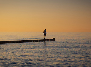 A woman on her way through the sea has almost reached the end.