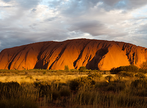 A beautiful sunset illuminates the holy mountain Ayers Rock.