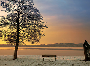 Reddish sunset at Einfelder lake in winter.
