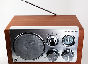 Object photo of a wooden radio with reflective metal front.