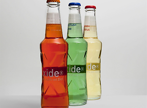 Three colorful bottles on a table.